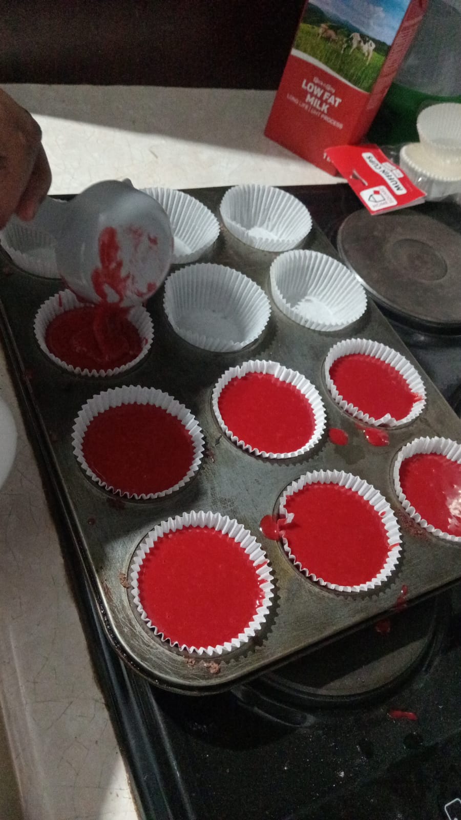 Red velvet muffin batter poured into liners